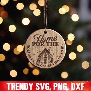 May include: A wooden Christmas ornament with the text "Home for the Holidays because I have to be". The ornament features a small house with a chimney and trees on either side.