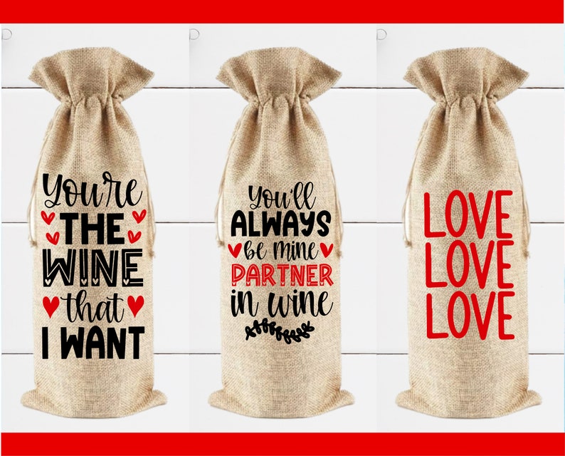 May include: Three burlap wine bottle gift bags with different sayings printed on them. The first bag says "You're the wine that I want". The second bag says "You'll always be mine partner in wine". The third bag says "Love Love Love".