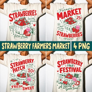 May include: Four cream-colored t-shirts with strawberry-themed designs. Each shirt features a different graphic: "Fresh Picked Strawberries," "Farmers Market," "Strawberry Patch," and "Strawberry Festival." The designs include strawberries, baskets, and text.