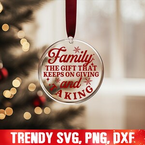 May include: A clear glass Christmas ornament with a red ribbon and the text "Family: The gift that keeps on giving and taking" in red lettering.