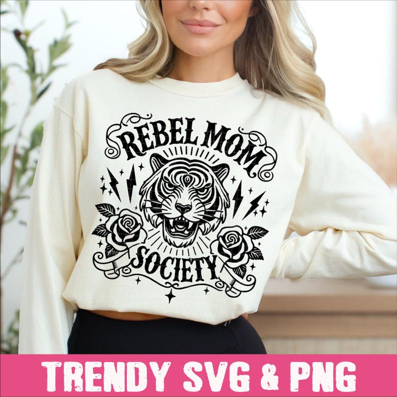 May include: A white sweatshirt with a black graphic design featuring a tiger with the text "Rebel Mom Society".