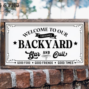 May include: A white wooden sign with black text that reads "Welcome to our Backyard Bar and Grill - Open Daily - Good Food, Good Friends, Good Times".
