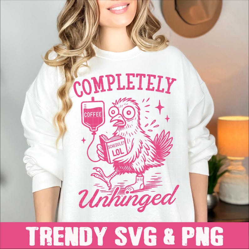 May include: A white sweatshirt with a pink graphic design of a chicken holding a book that says "Schedule? LOL" and a coffee IV bag. The text on the sweatshirt says "Completely Unhinged".