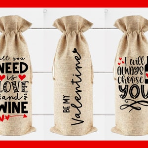May include: Three burlap wine bottle bags with different Valentine's Day themed sayings. The first bag says "all you need is love and wine". The second bag says "Be my Valentine". The third bag says "I will always choose you".