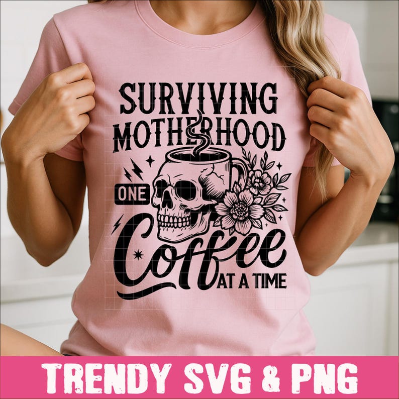 May include: Pink t-shirt with a black and white graphic design. The graphic features a skull holding a coffee cup with the text "Surviving Motherhood One Coffee At A Time".