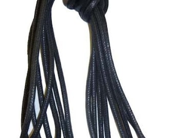 May include: A bundle of black shoelaces, knotted at the top. The laces are round and appear to be made of a durable, textured material. The tips are capped, and the background is white.