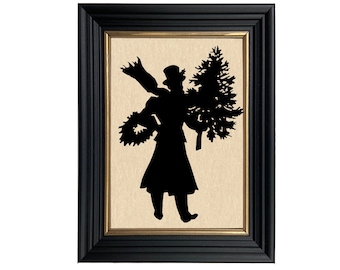 May include: A black silhouette of a person carrying a Christmas tree and a wreath in a black frame with a gold mat.