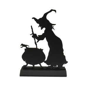 May include: Black silhouette of a witch stirring a cauldron with a cat beside her. The witch is wearing a pointed hat and a long dress. The silhouette is on a black base.