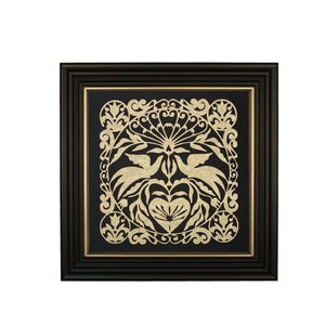 May include: A framed black and gold paper cut art piece with a symmetrical design of stylized birds and floral elements.