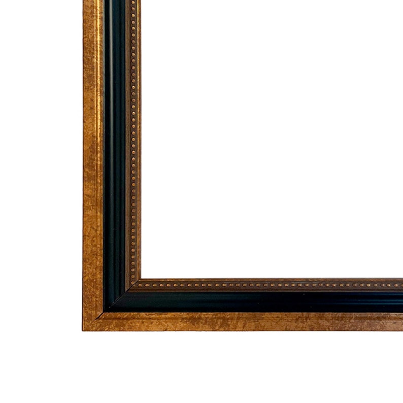 May include: A black and gold picture frame with a decorative border. The frame has a simple, classic design.