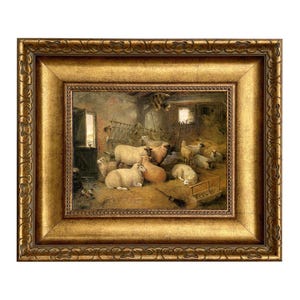 May include: A framed painting depicts sheep resting in a barn. The artwork features a gold ornate frame. The sheep are various shades of white and tan, with some lying down on the hay-covered floor. The barn has a rustic interior.