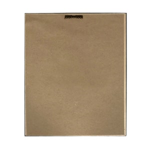 May include: The back of a framed picture with a brown cardboard backing. The frame is black and has a small metal hanger on the top.