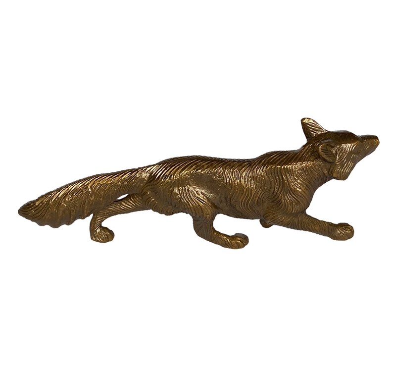 May include: A gold-colored metal figurine of a fox running. The fox is detailed with fur and has a long tail.