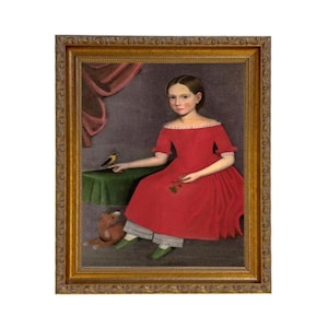 May include: A framed portrait of a young person in a red dress, seated with a small bird on a table. The portrait has a gold frame and features a teddy bear and green shoes.