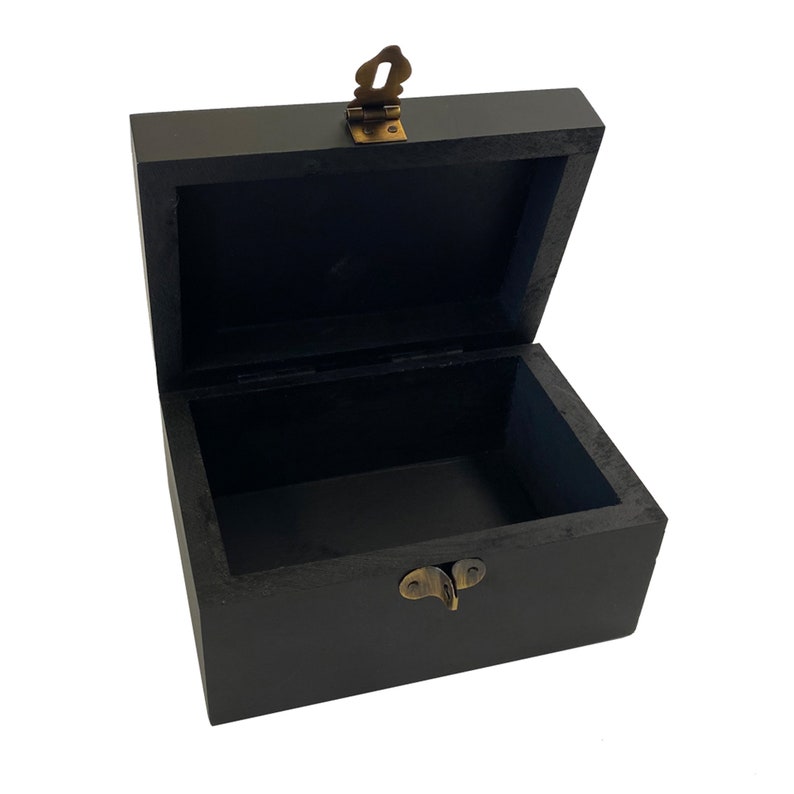 May include: A black wooden box with a brass latch. The box is open and empty.