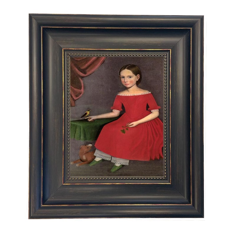 May include: Framed portrait of a young person in a red dress, seated with a small bird and a stuffed animal. The painting has a dark blue frame with gold trim, and the background is a muted purple.