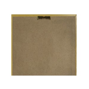 May include: The back of a framed picture with a gold frame. The frame has a sawtooth hanger on the back.
