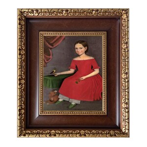 May include: A framed portrait of a young person in a red dress, seated with a bird and a toy. The painting is in a dark brown frame with gold accents. The subject is holding a flower.