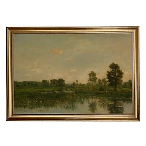 May include: A painting of a landscape with a river, trees, and a cloudy sky. The river is reflecting the sky and the trees. The painting is framed in a gold frame.