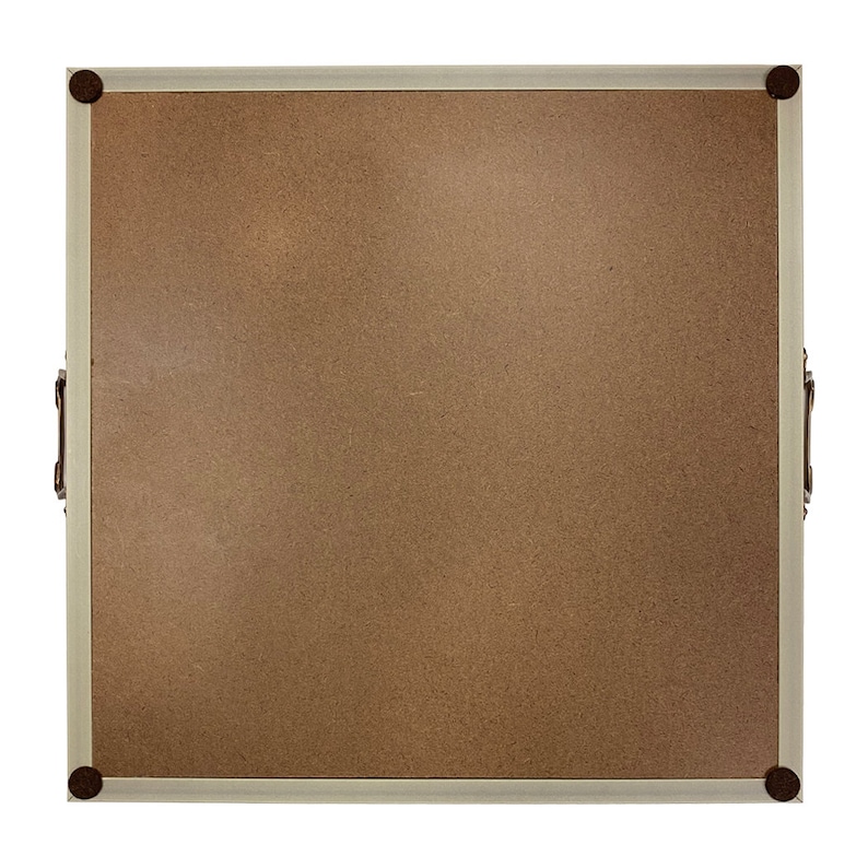 May include: A light brown corkboard with a white frame and rounded corners. The frame has a decorative metal trim and four metal corner accents. The corkboard has two metal handles on the sides.