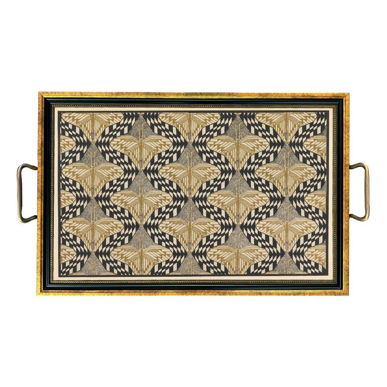 May include: Rectangular serving tray with a gold frame and handles. The tray's interior features a repeating geometric pattern in black, beige, and gold. The handles are a dark brass color, and the frame has a black border.