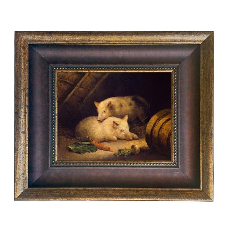 May include: A framed painting depicts two pigs in a barn setting. One pig is lying down, while the other is standing behind it. A carrot and other vegetables are in the foreground. The frame is dark brown with gold accents.