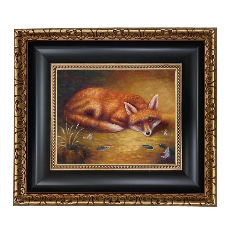 May include: A framed painting of a red fox resting on the ground. The fox has white fur on its chest and ears. The painting is in a black frame with a gold ornate outer frame.
