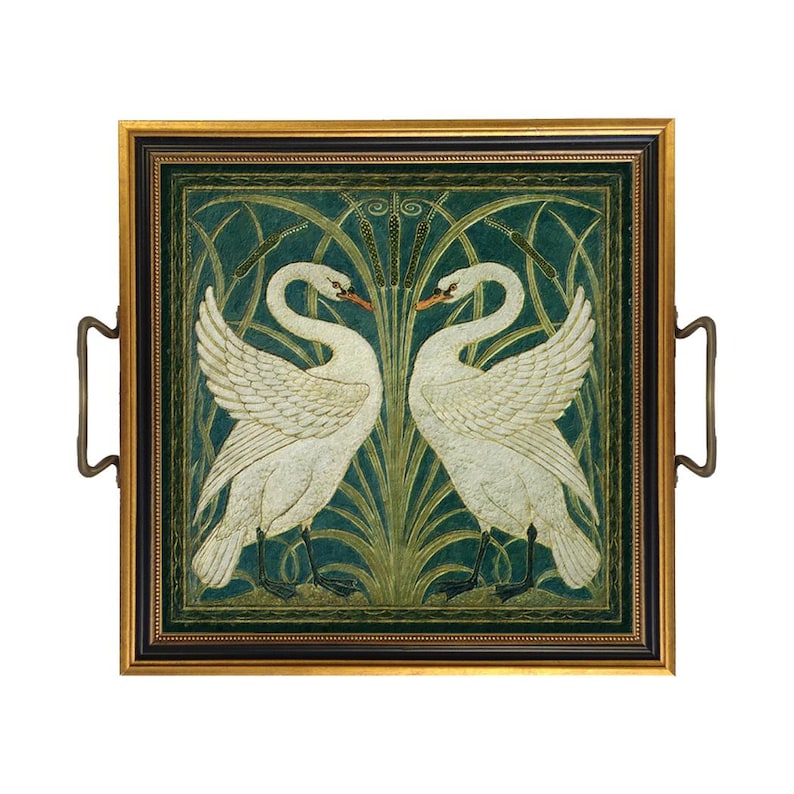 May include: A square serving tray with a gold and black frame and two metal handles. The center features a detailed illustration of two white swans facing each other, surrounded by green reeds and cattails against a dark green background.