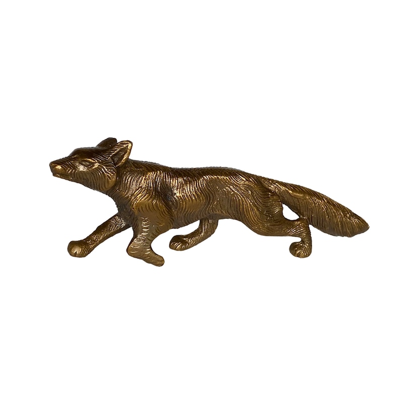 May include: A bronze figurine of a fox running, with a detailed textured surface.