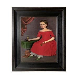 May include: Framed folk art portrait of a young person in a red dress, seated with a bird on a table and a stuffed animal. The painting has a dark wooden frame and a vintage aesthetic.