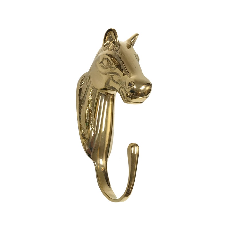 May include: A gold-toned metal horse head coat hook. The hook is curved and the horse's head is detailed with a mane and a realistic expression.