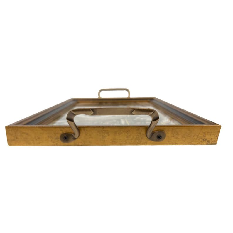 May include: A rectangular gold-colored serving tray with a glass top and two curved handles on the sides, and a single handle on top. The tray has a dark border around the glass and is set against a white background.