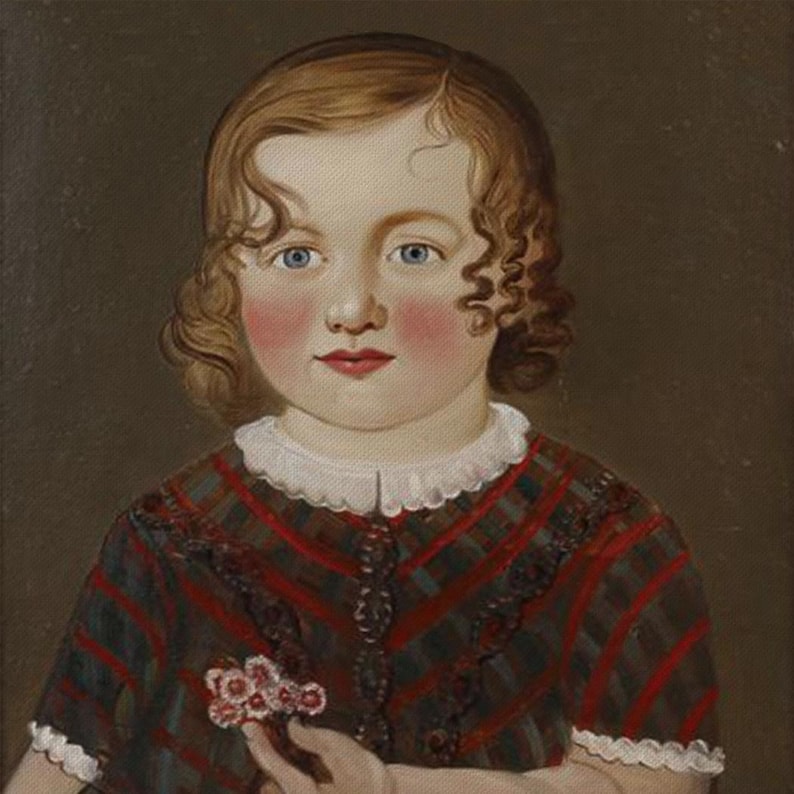 May include: A portrait of a young child with blue eyes and rosy cheeks. The child has curly brown hair and is wearing a dress with red and green stripes and a white collar. The child is holding a small bouquet of pink flowers.