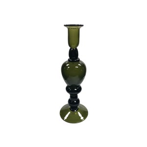 May include: A tall green glass candle holder with a black base and a wide, round base.