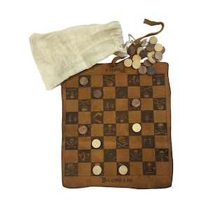 May include: A brown leather checkerboard game with a pirate theme, featuring skull and crossbones graphics. Includes wooden checkers and a drawstring bag. The board is approximately 25 cm square.