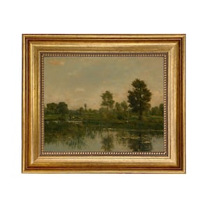 May include: A framed oil painting depicting a tranquil landscape with a lake, trees, and a cloudy sky. The painting is in a gold frame.