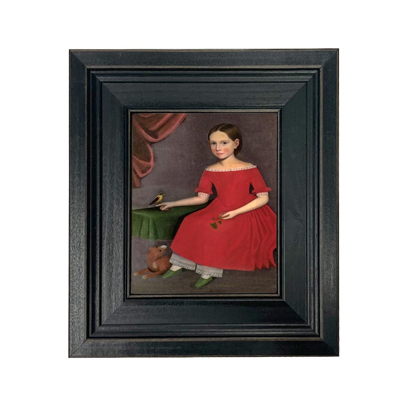 May include: Framed portrait of a young person in a red dress, seated with a bird on a table. The painting features a dark wooden frame and a muted color palette, with a teddy bear at the subject's feet. The background includes a draped curtain.