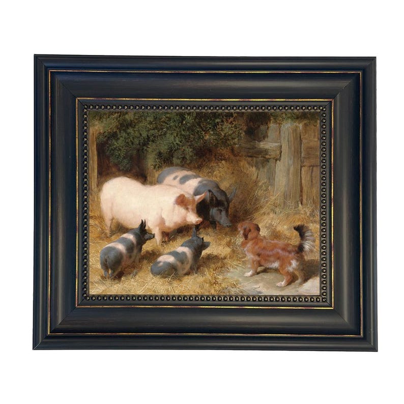 May include: Framed artwork depicting a farm scene with pigs and a dog. The painting features a light pink pig, several black and white pigs, and a brown and white dog. The artwork is set in a barn with hay and greenery, framed in a black frame.