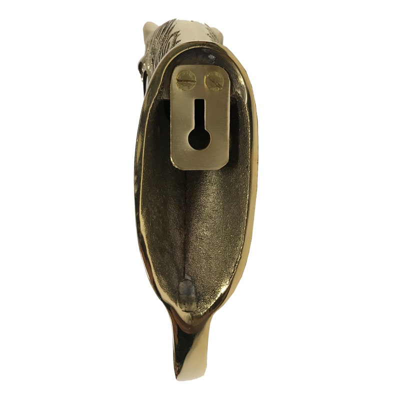 May include: A gold-toned metal hook with a decorative animal head design. The hook has a keyhole on the back for mounting.
