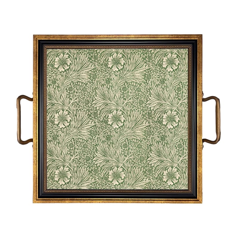 May include: Square serving tray with a black and gold frame and brass handles. The tray's interior features a green and cream floral pattern. The tray is designed for serving food and drinks.