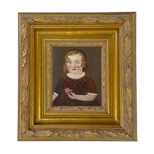 May include: A framed portrait of a young child. The child is wearing a red and black plaid dress and holding a small flower. The portrait is in a gold ornate frame.