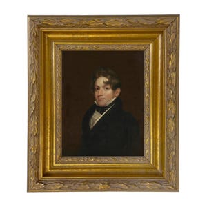 May include: An oil painting portrait of a person with brown hair, wearing a dark coat, a white collared shirt, and a black cravat. The portrait is encased in a rectangular, ornate gold-coloured frame featuring a detailed leaf-patterned border.