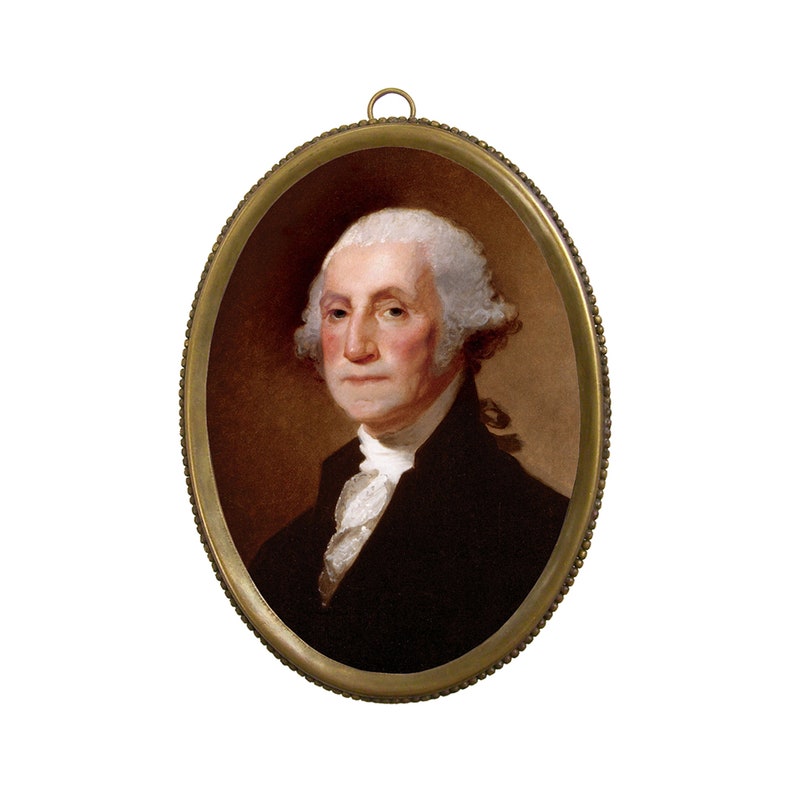 Op de afbeelding: Een ingelijst portret van George Washington, de eerste president van de Verenigde Staten. Het portret is in een ovale lijst met een gouden afwerking.