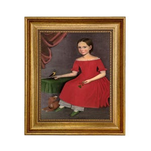 May include: A framed portrait of a young person in a red dress, seated with a small table and a toy bear. A bird perches on the table. The painting has a gold frame and a vintage aesthetic.