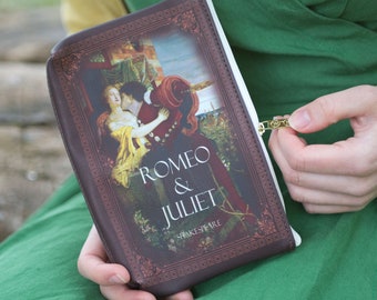 May include: A brown leather zippered pouch with a vintage book cover design. The cover features an illustration of Romeo and Juliet with the title "Romeo & Juliet" and the author "Shakespeare".