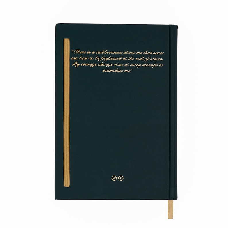 May include: A dark teal journal with gold text and a gold ribbon bookmark. The text reads, "There is a stubbornness about me that never can bear to be frightened at the will of others. My courage always rises at every attempt to intimidate me."