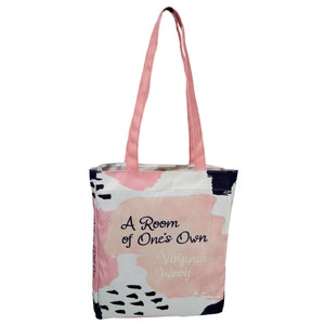 May include: A pink and white tote bag with abstract brushstrokes and black accents. The bag has a quote from Virginia Woolf's book "A Room of One's Own" printed on it.
