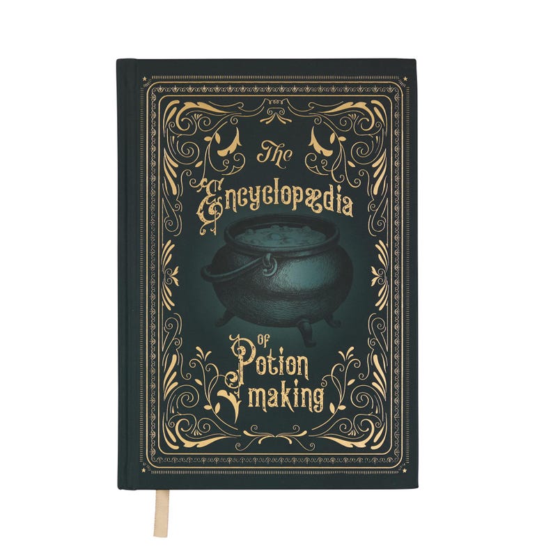 May include: A dark green hardcover book titled "The Encyclopedia of Potion Making." The cover features a cauldron illustration and ornate gold-colored scrollwork. A cream-colored ribbon bookmark is visible.