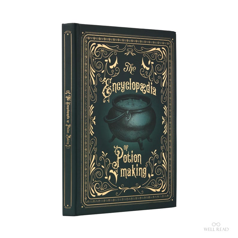 May include: A hardcover book titled "The Encyclopedia of Potion Making." The cover is dark teal with gold ornate designs and a cauldron illustration. The spine also features the title. The book is a fantasy-themed item.