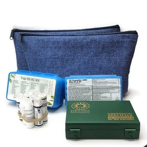 May include: A blue textured fabric pouch with two zippers, two blue plastic cases labeled Top 50 6C Kit and 50 Remedies 200C Kits #3 & #4, a cluster of small white vials held by a rubber band, and a green box labeled Helios Homoeopathy 36 Remedies.